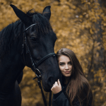 A girl hugging a black horse, an image seen often by the MirrorMePR equestrian PR team.