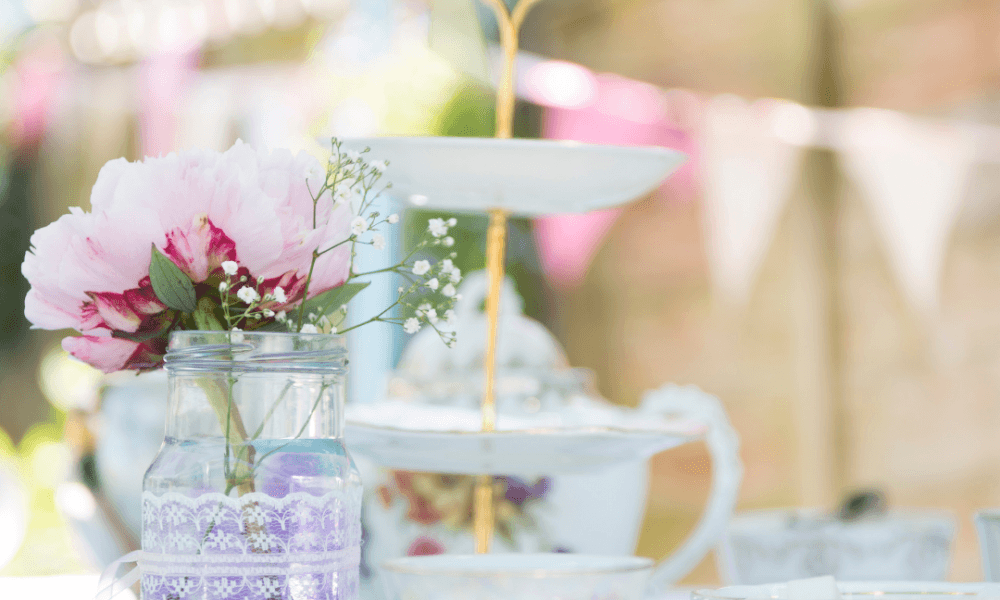 A selection of white tea cups and pink flowers