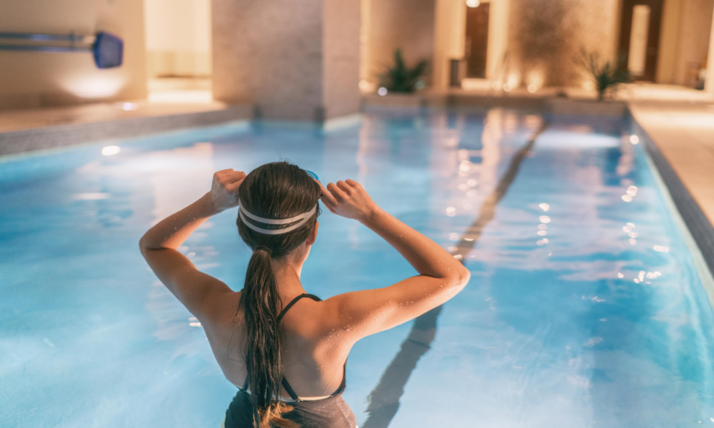Girl in swimming pool with goggles on in one of the 6 best places to visit in the UK