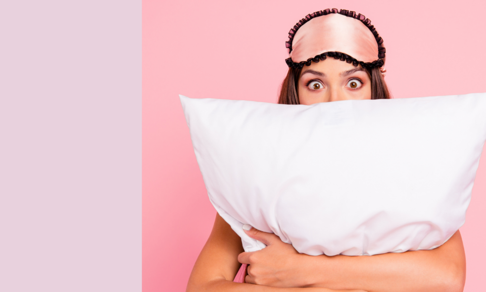 woman with eye mask and pillow to help get a good night's sleep