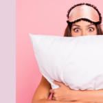 woman with eye mask and pillow to help get a good night's sleep