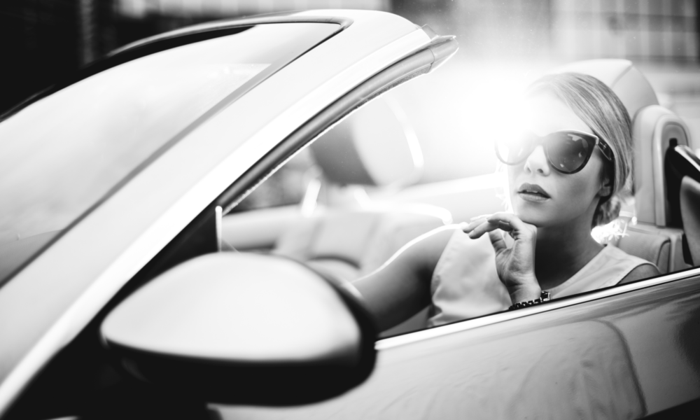woman sitting in luxury car