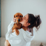 Woman Kissing Dog Aware Of The Joys of Pet Ownership
